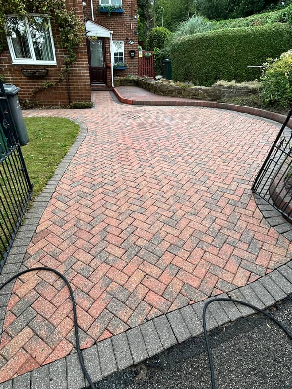 Curved red block-paved drive with a grey border, after cleaning