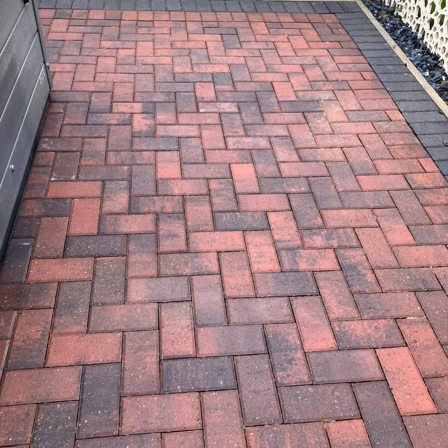 A cleaned red and charcoal block-paved lodge driveway