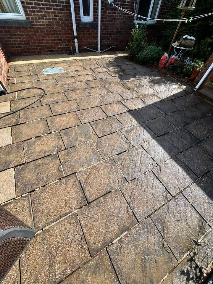 The same yard after cleaning, weeds gone and the riven flags wet and clean