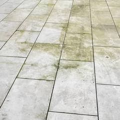 Pale porcelain slabs with a light green film across them